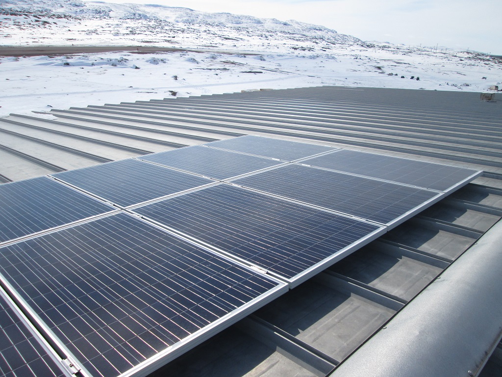 Solar panels with northern snowscape in the background