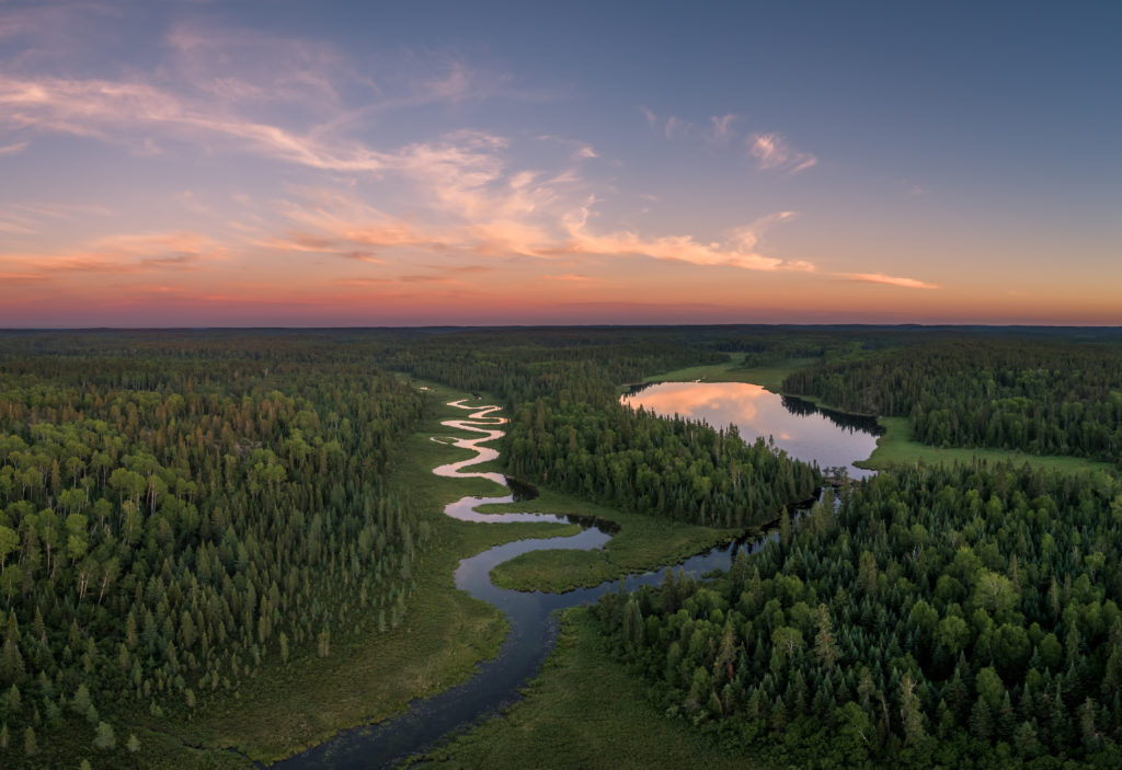 Aerial view of a winding river and trees in Northern Ontario