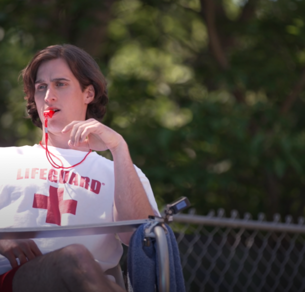 Lifeguard sitting with whistle