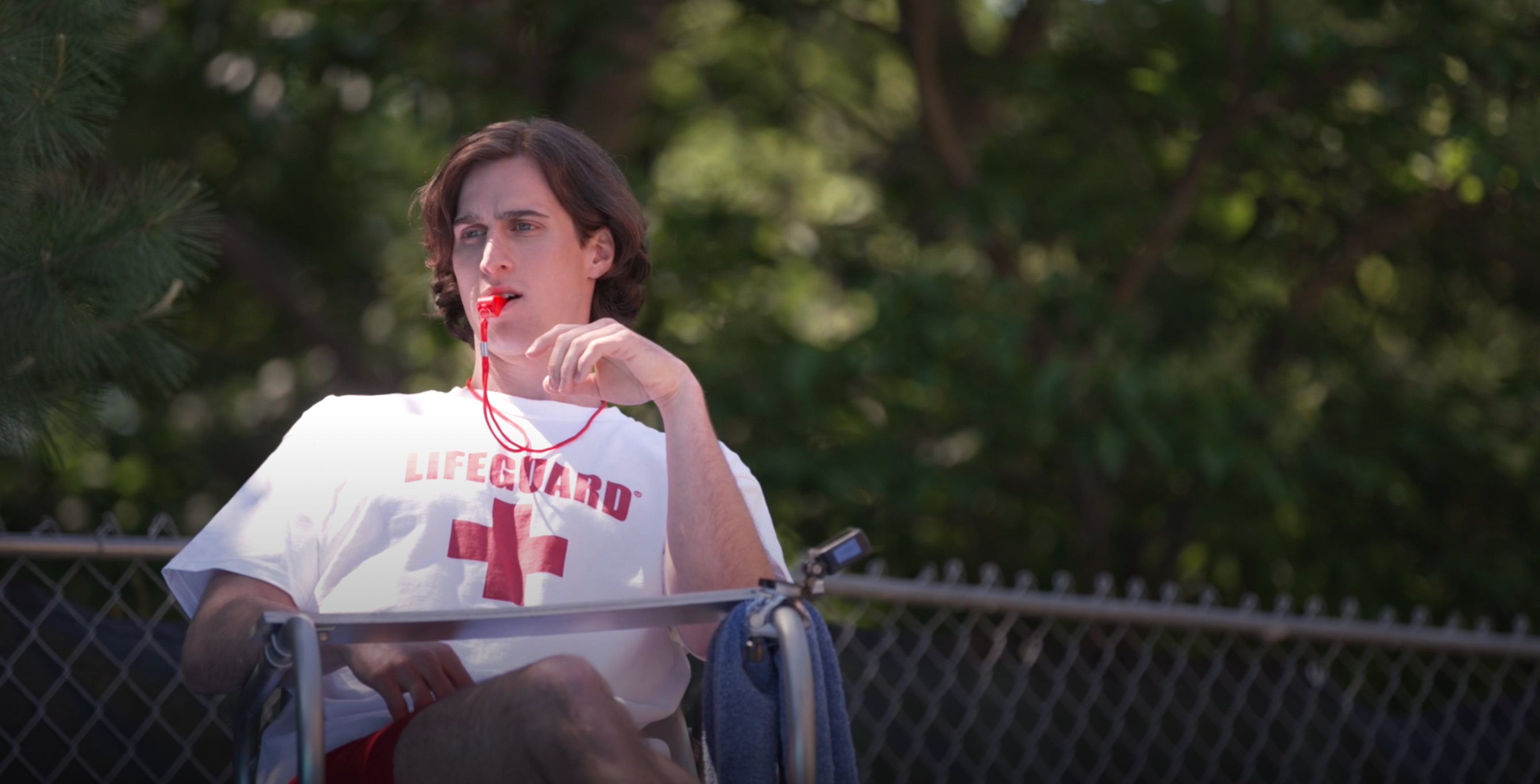 Lifeguard sitting with whistle