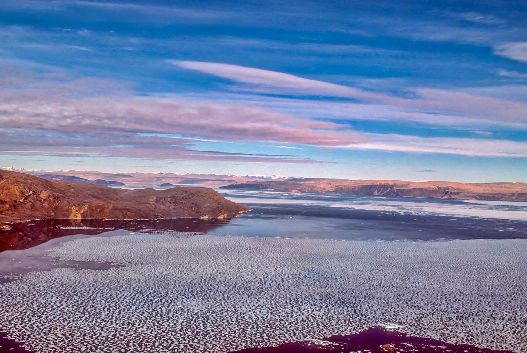 An island during a colourful sunset in the High Arctic