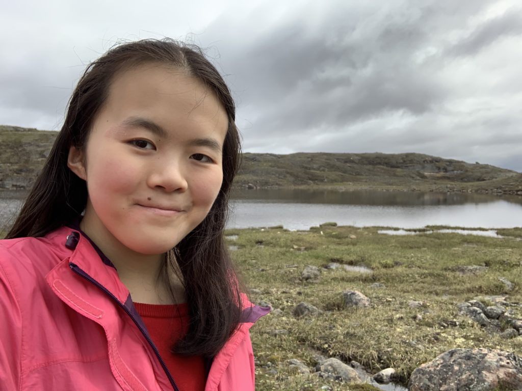 photo of Katie Yu, WWF-Canada intern, beside a lake near Iqaluit, Nunavut