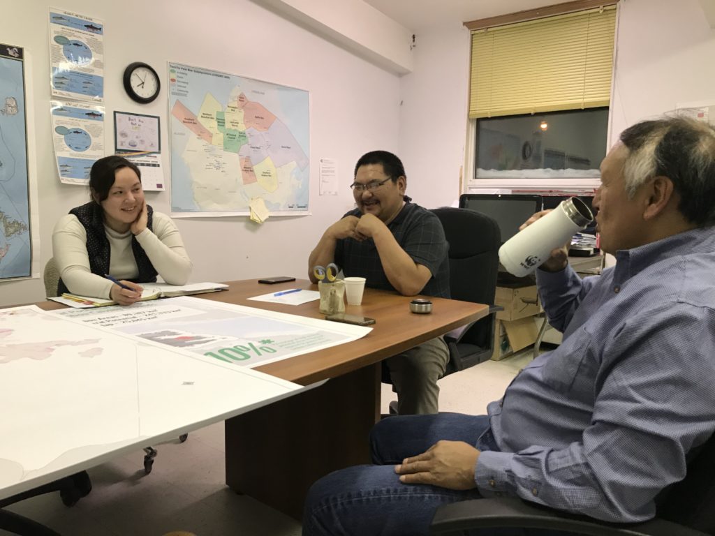 Two community members from Whale Cove and WWF-Canada's lead Arctic specialist discussing the polar bear patrol program.