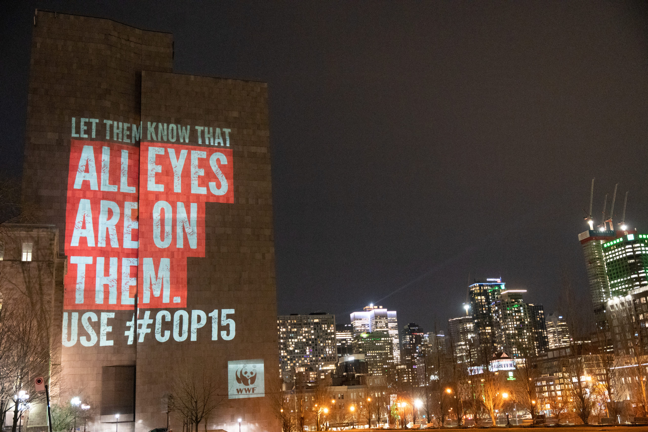 A projection on the side of the Palais de Justice building that reads: “Let them know that all eyes are on them” 