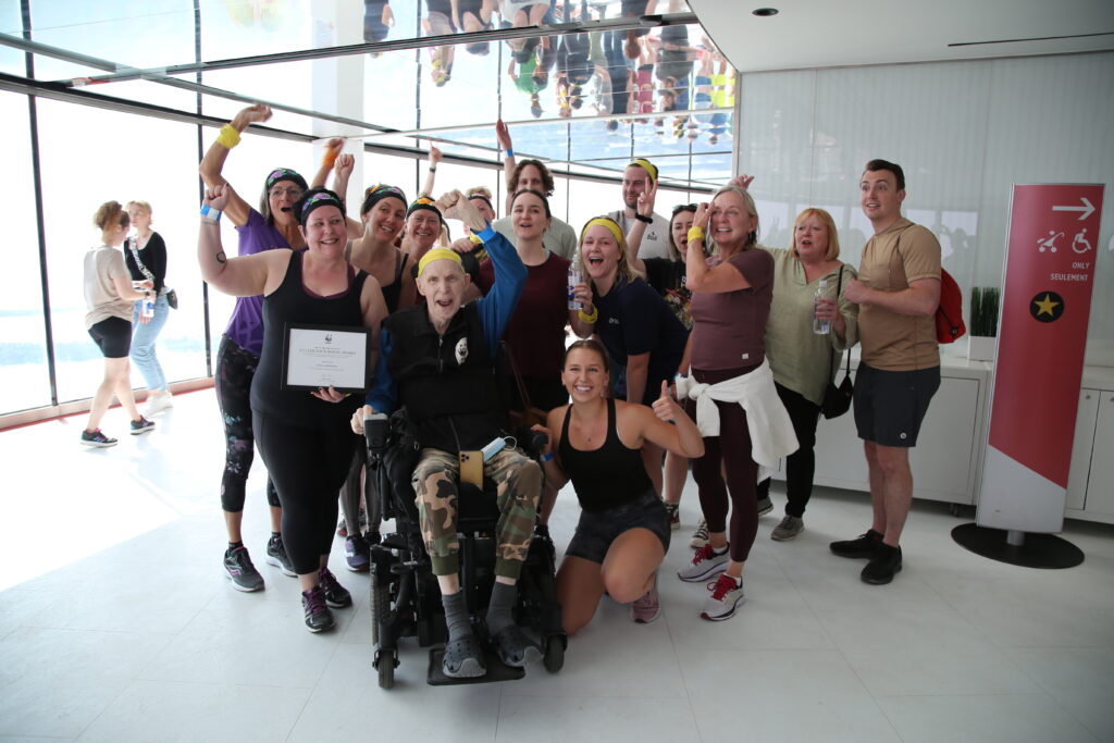 Liisa Ladouceur, Julian Backhouse and their teams pose with the Julian Backhouse Award certificate.