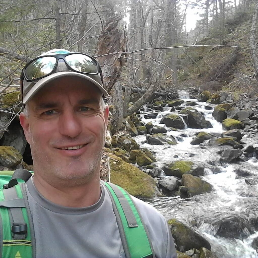 Ben Whalen, Project Manager at the Kennebecasis Watershed Restoration Committee, on the banks of a local river.