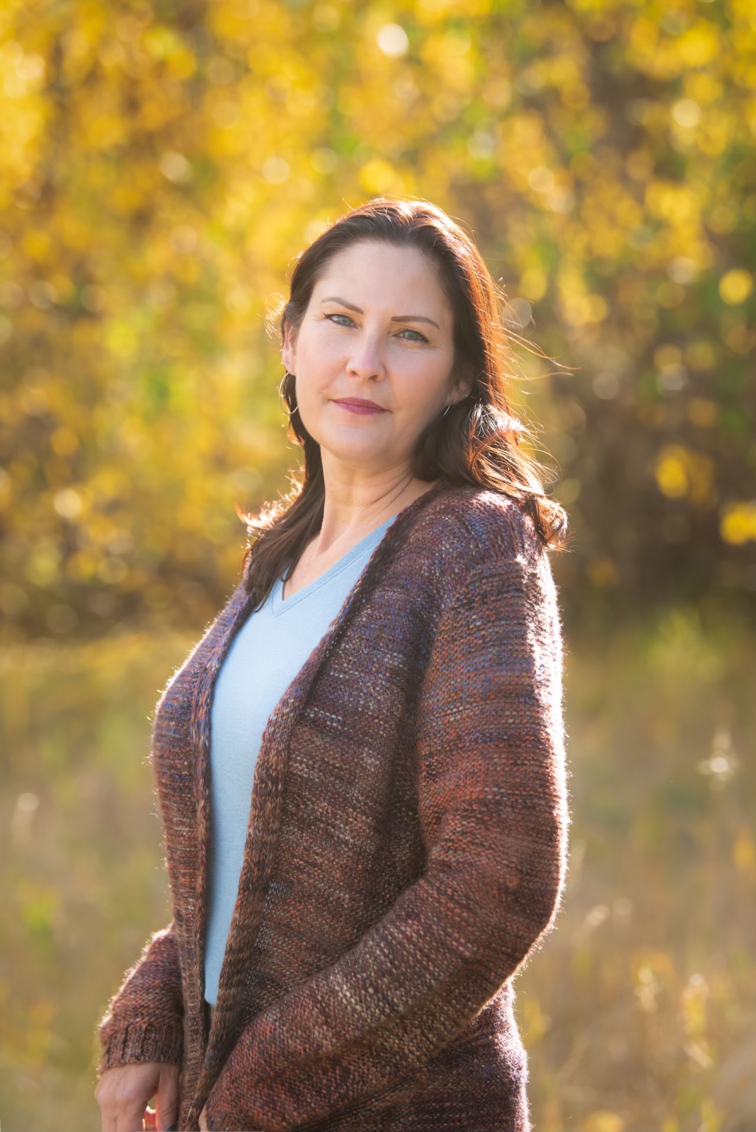 First Nations woman standing in a forest in the fall