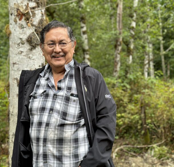 Katzie First Nation man standing in a green forest