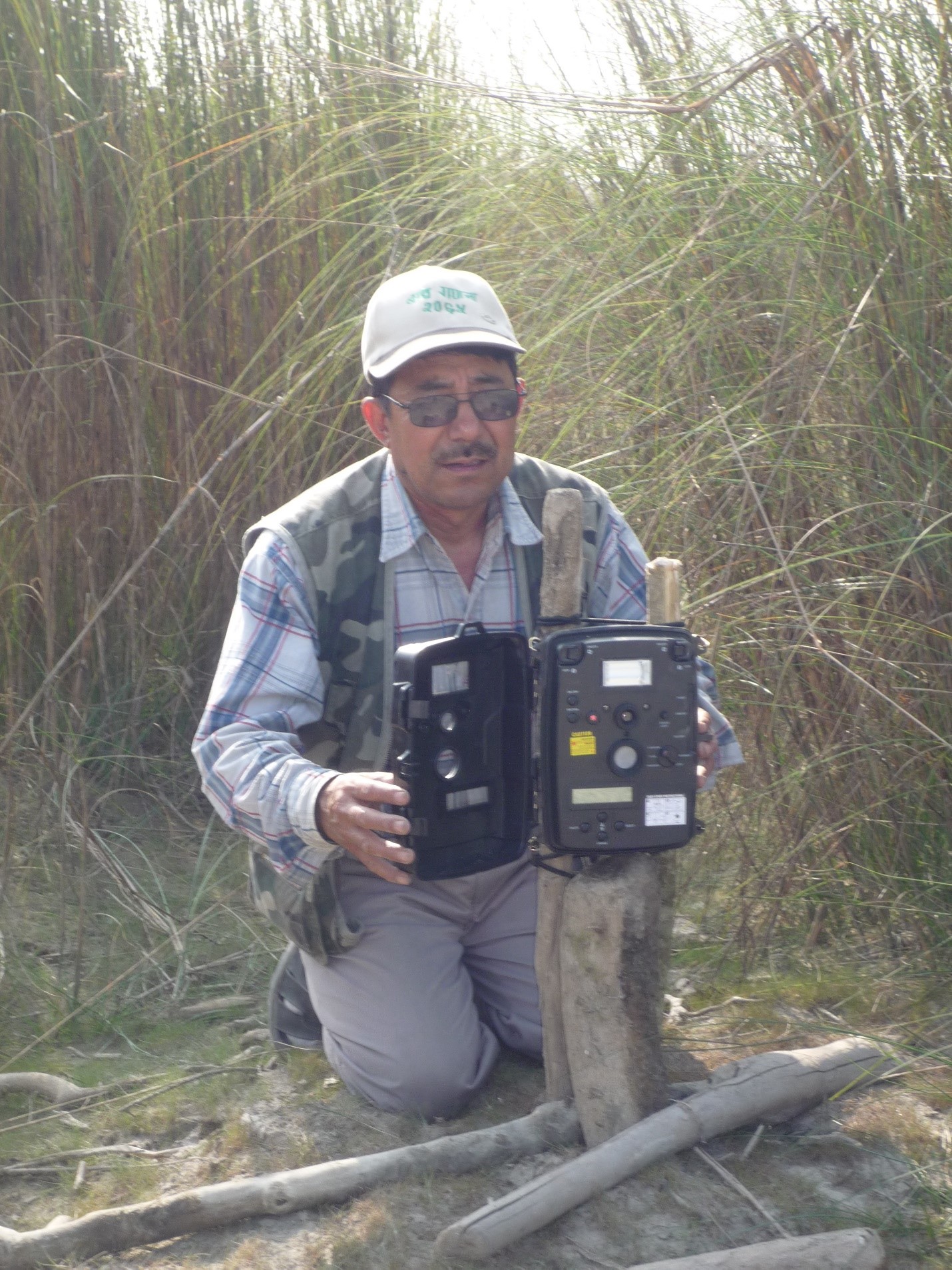 Man holding a camera trap